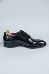 Black brogue Oxford shoes with contrast lining, perfect for formal wear and business.